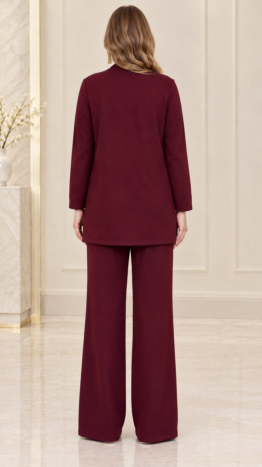 Back view of women's burgundy two-piece trouser suit set
