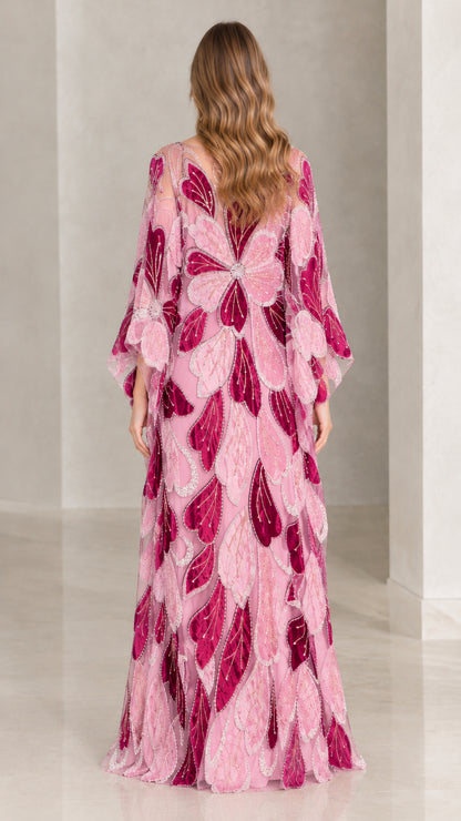 Back view of model in pink floral leaf embroidered floor-length kaftan