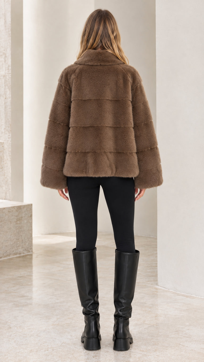 Back view of model wearing Mocha Brown faux fur jacket showcasing horizontal paneling