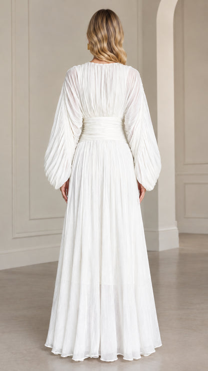 Back view of woman wearing elegant white pleated evening maxi gown
