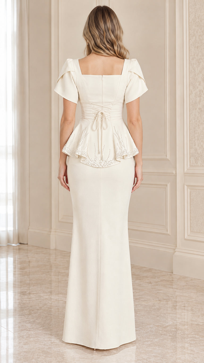 Back view of ivory maxi evening gown showing tie back waist and peplum hem