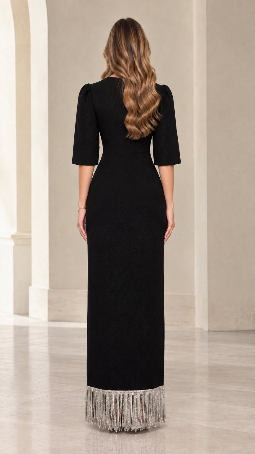 Back view of black maxi evening dress showing sleek silhouette and fringe trim