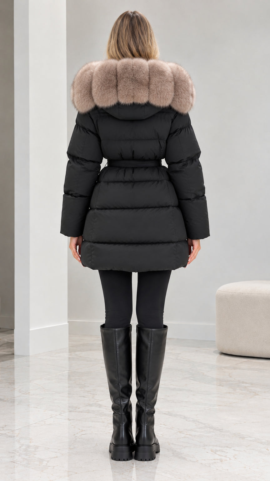 Back view of model showing black mid-length quilted puffer coat