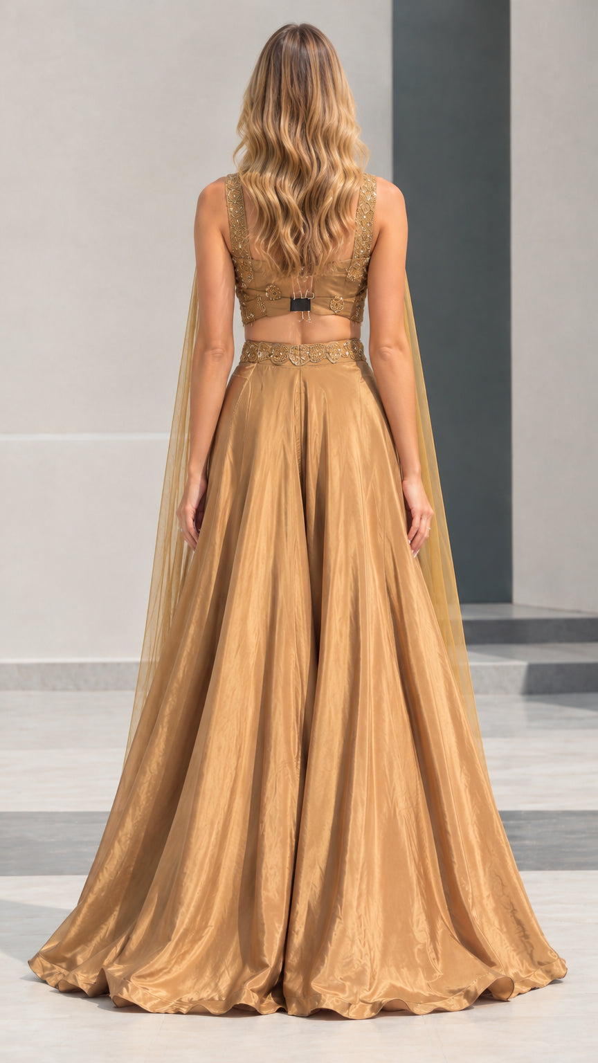 Back view of gold cape evening gown set showing open back and skirt drape