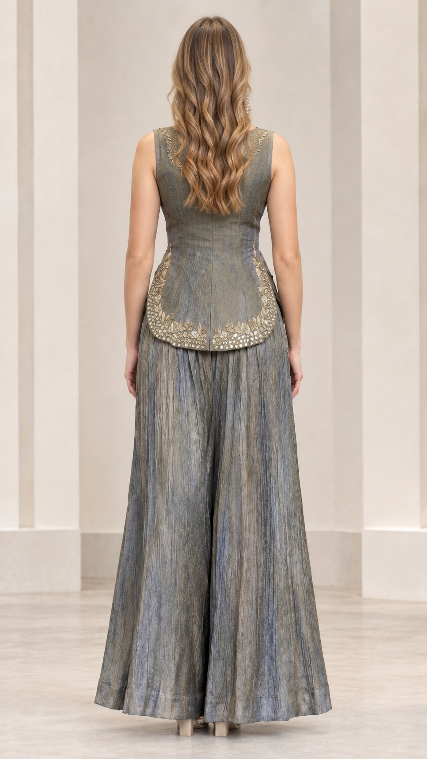 Back view of slate grey peplum top and flowing wide-leg trousers