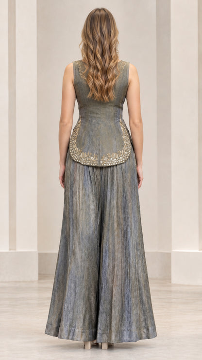 Back view of slate grey peplum top and flowing wide-leg trousers