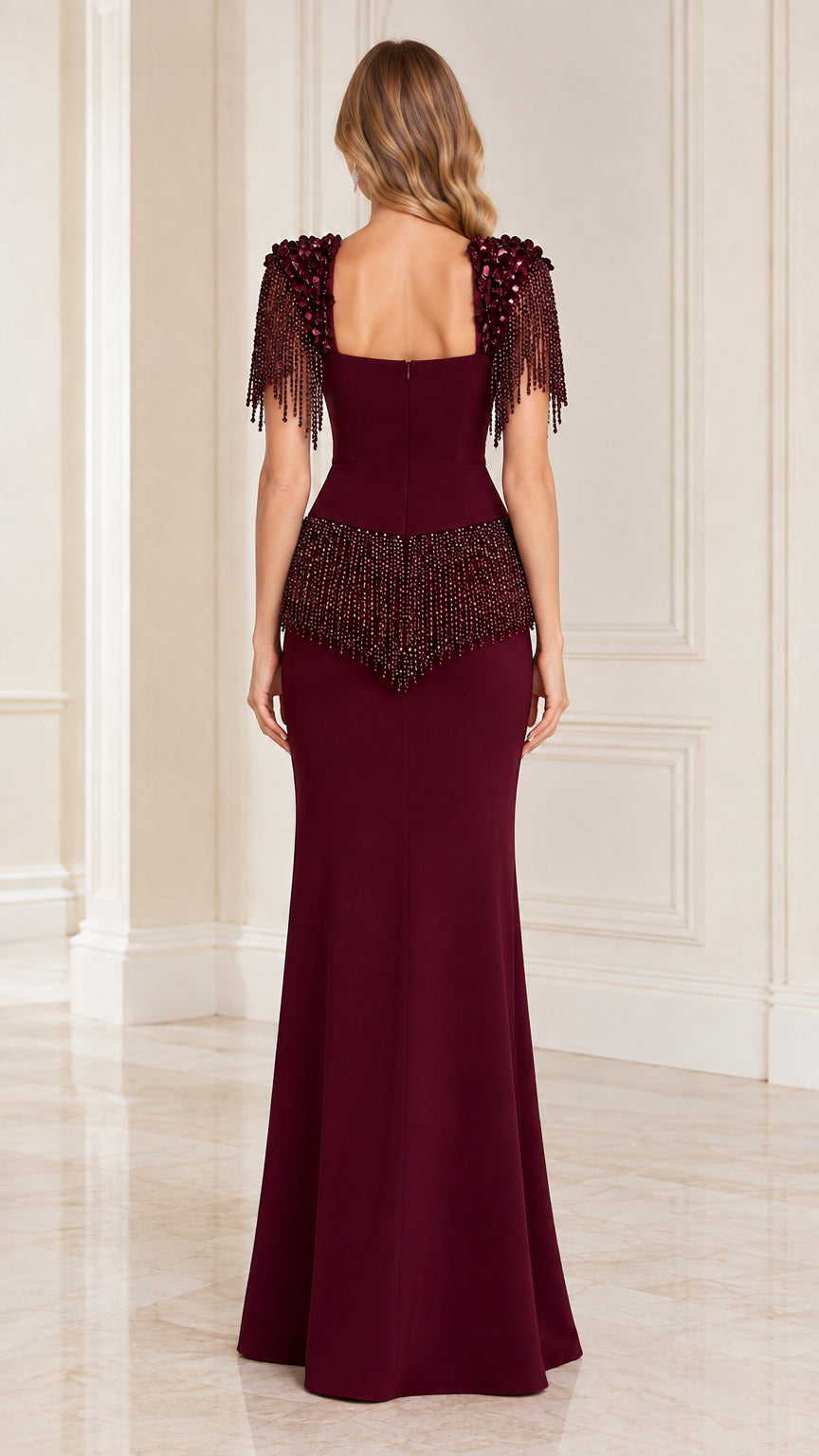 Back view of model in burgundy floor-length gown showing square back and fringe detail