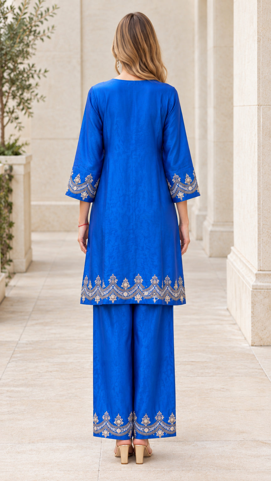 Back full-length view of royal blue two-piece tunic and straight pants outfit
