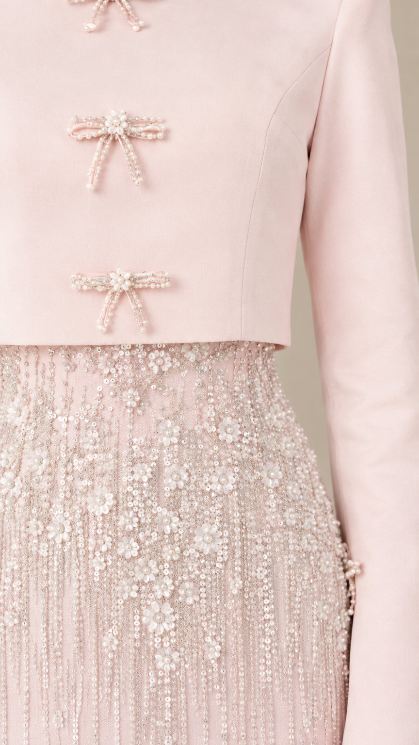 Close-up detail of beaded bow clasps and intricate floral sequin embroidery