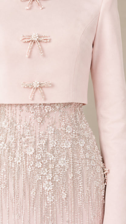 Close-up detail of beaded bow clasps and intricate floral sequin embroidery