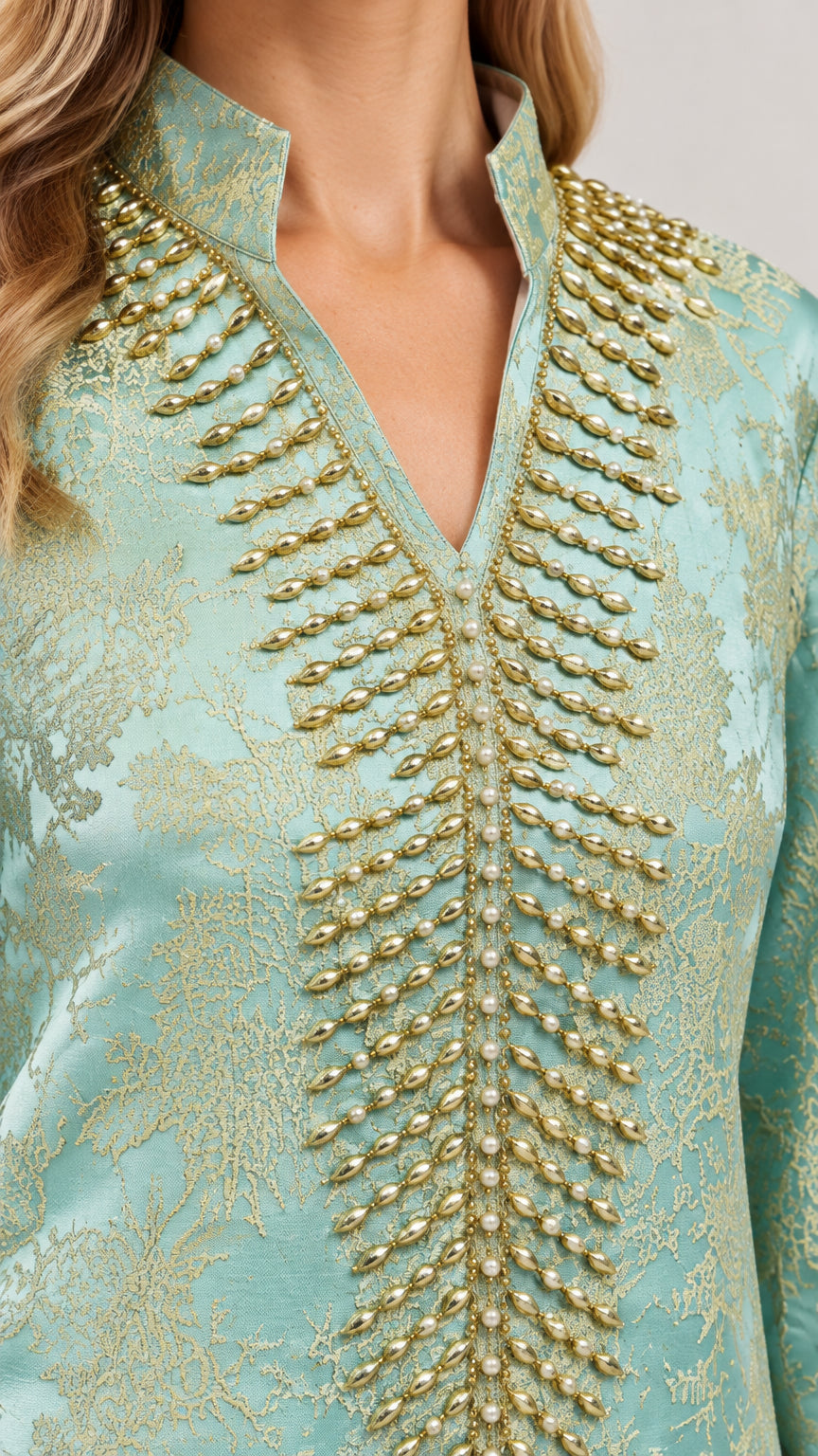 Close up of gold beaded embellishment on Mint Green jacquard split neckline