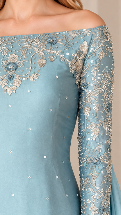 Close-up detail of delicate floral sequin and bead embroidery on off-the-shoulder neckline and sleeve