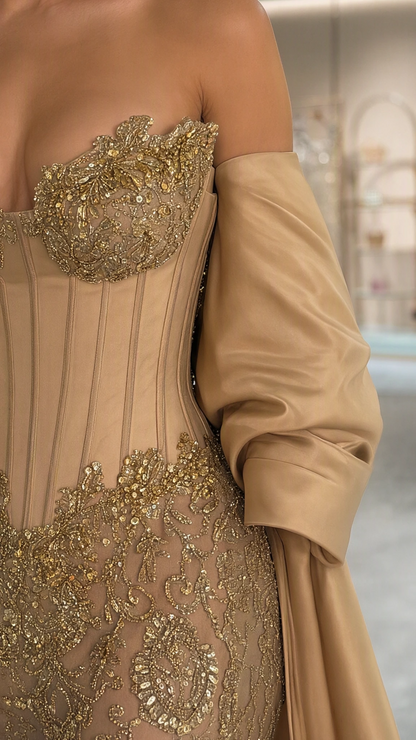 Close-up of champagne corset bodice with intricate gold embroidery and boning details