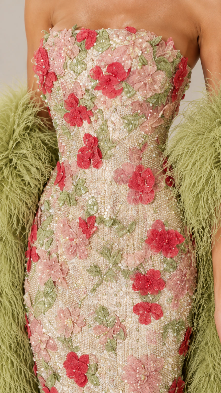 Close-up detail of 3D floral appliques, beads, and embroidery on strapless bodice