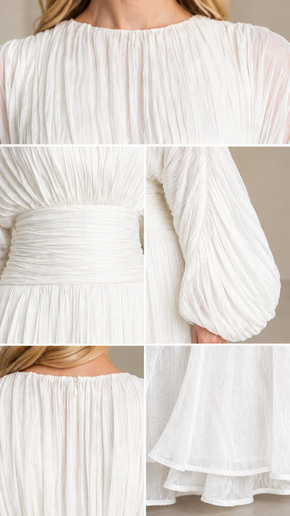 Close-up details of neckline, ruched waist, balloon sleeves, and hem on white maxi dress