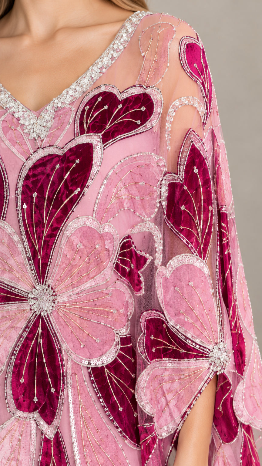 Close-up detail of crystal-beaded neckline and velvet-textured petal embroidery on pink kaftan
