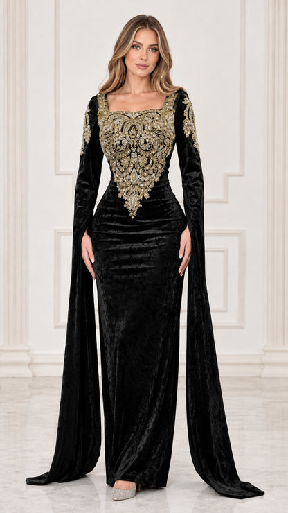 Front view of black velvet evening gown with ornate gold embroidery and cape sleeves