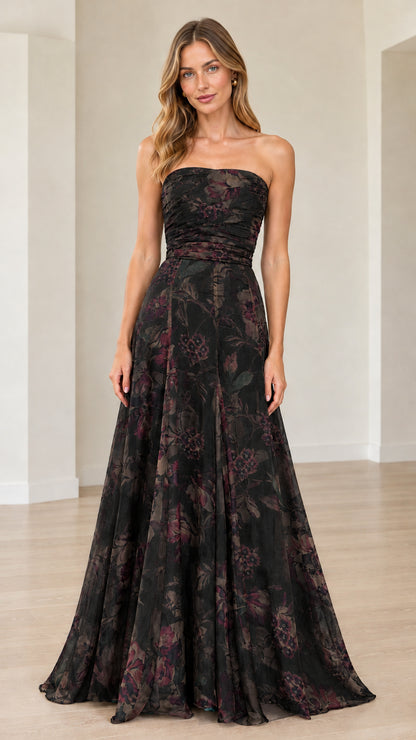 Front view of model wearing black floral strapless maxi gown