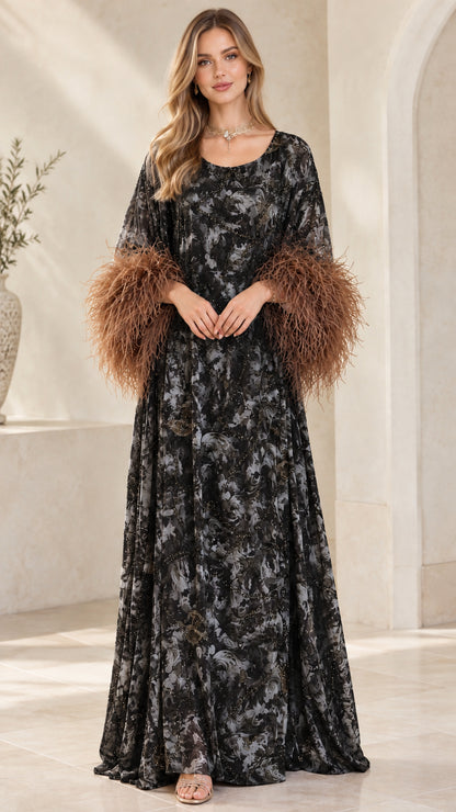 Model wearing black and grey printed kaftan dress with brown feather cuffs