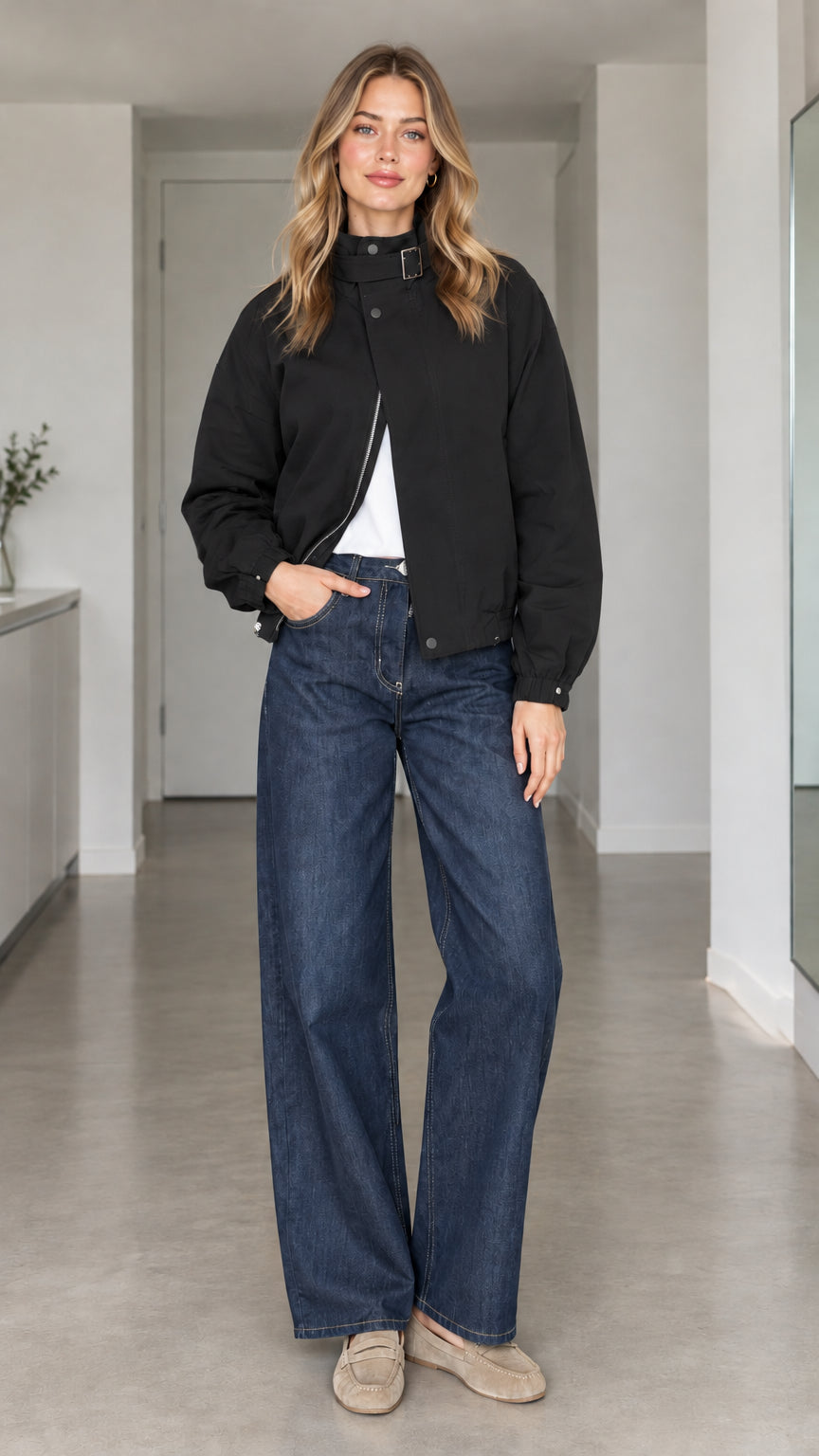 Front view of model wearing black high-collar buckle bomber jacket