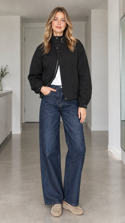 Front view of model wearing black high-collar buckle bomber jacket