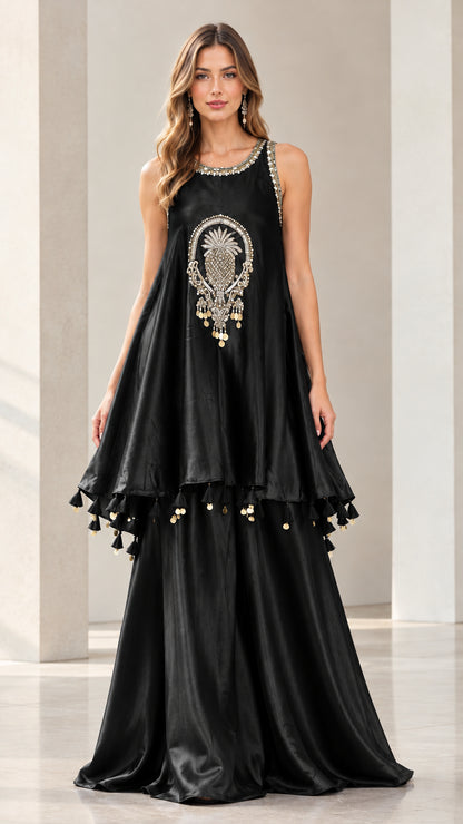 Front view of woman wearing Black embellished sleeveless peplum tunic and palazzo pants set