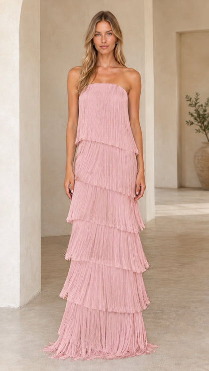 Full-length view of blush pink tiered fringe strapless maxi dress
