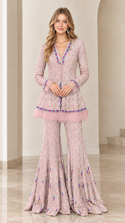Front view of model wearing Dusty Pink embroidered peplum tunic and flared pants set