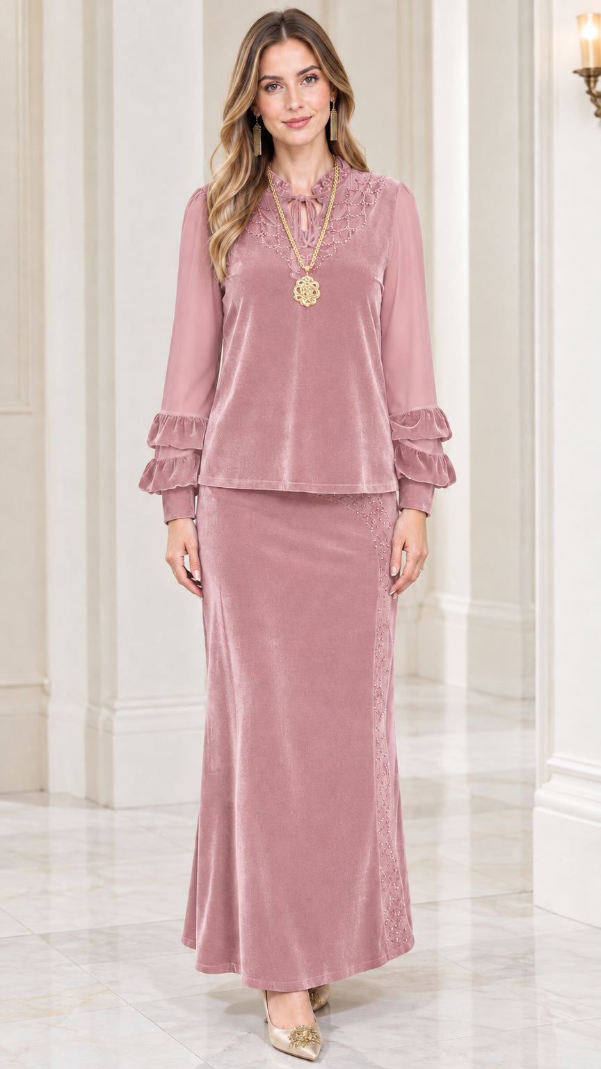 Front view of model wearing dusty pink velvet two-piece maxi skirt set