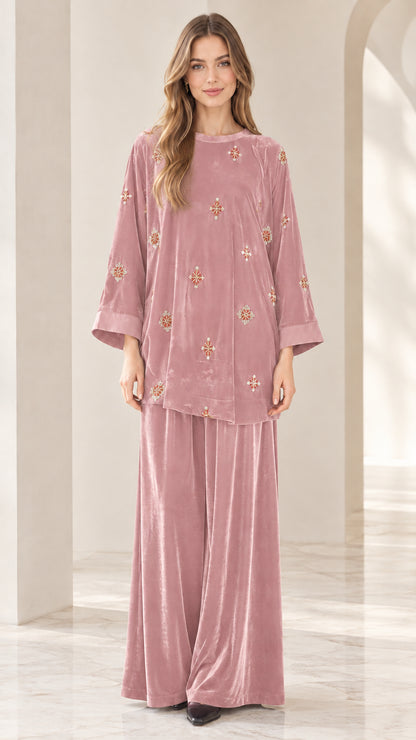 Front view of model wearing dusty rose pink embroidered velvet two piece set