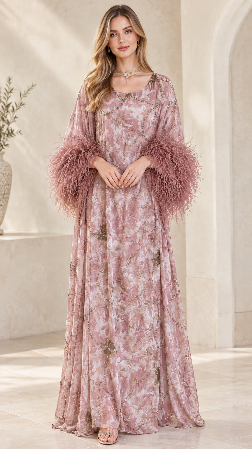 Model wearing dusty pink printed kaftan maxi gown with tonal pink feather cuffs