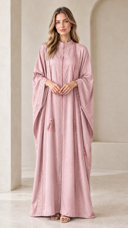 Front view of woman wearing Dusty Pink embroidered batwing kaftan maxi dress with tassels