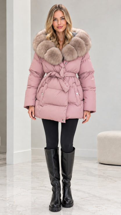 Front view of model wearing dusty pink belted quilted puffer coat