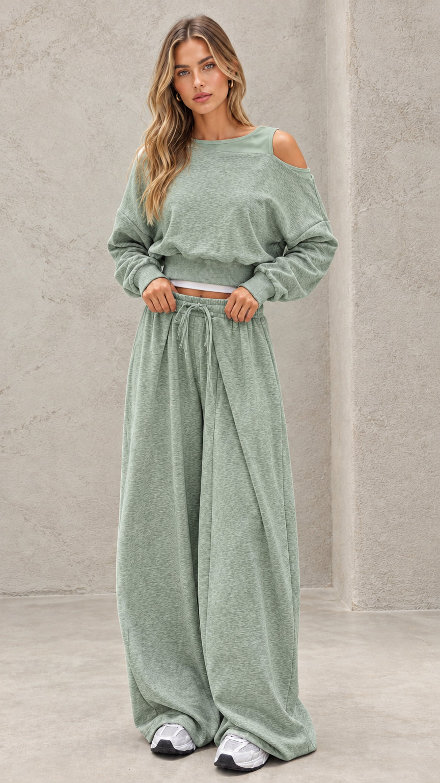 Full-length view of model wearing sage green cut out lounge set with wide leg sweatpants