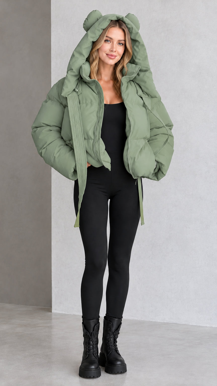 Model wearing sage green bear ear hooded cropped puffer jacket