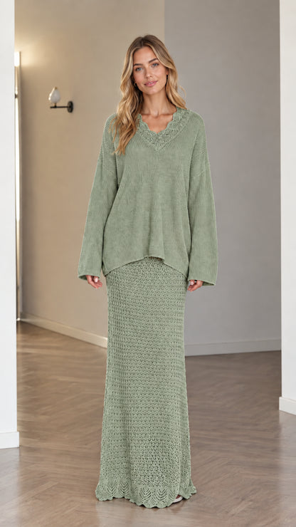 Model wearing sage green two-piece crochet V-neck sweater and maxi skirt set