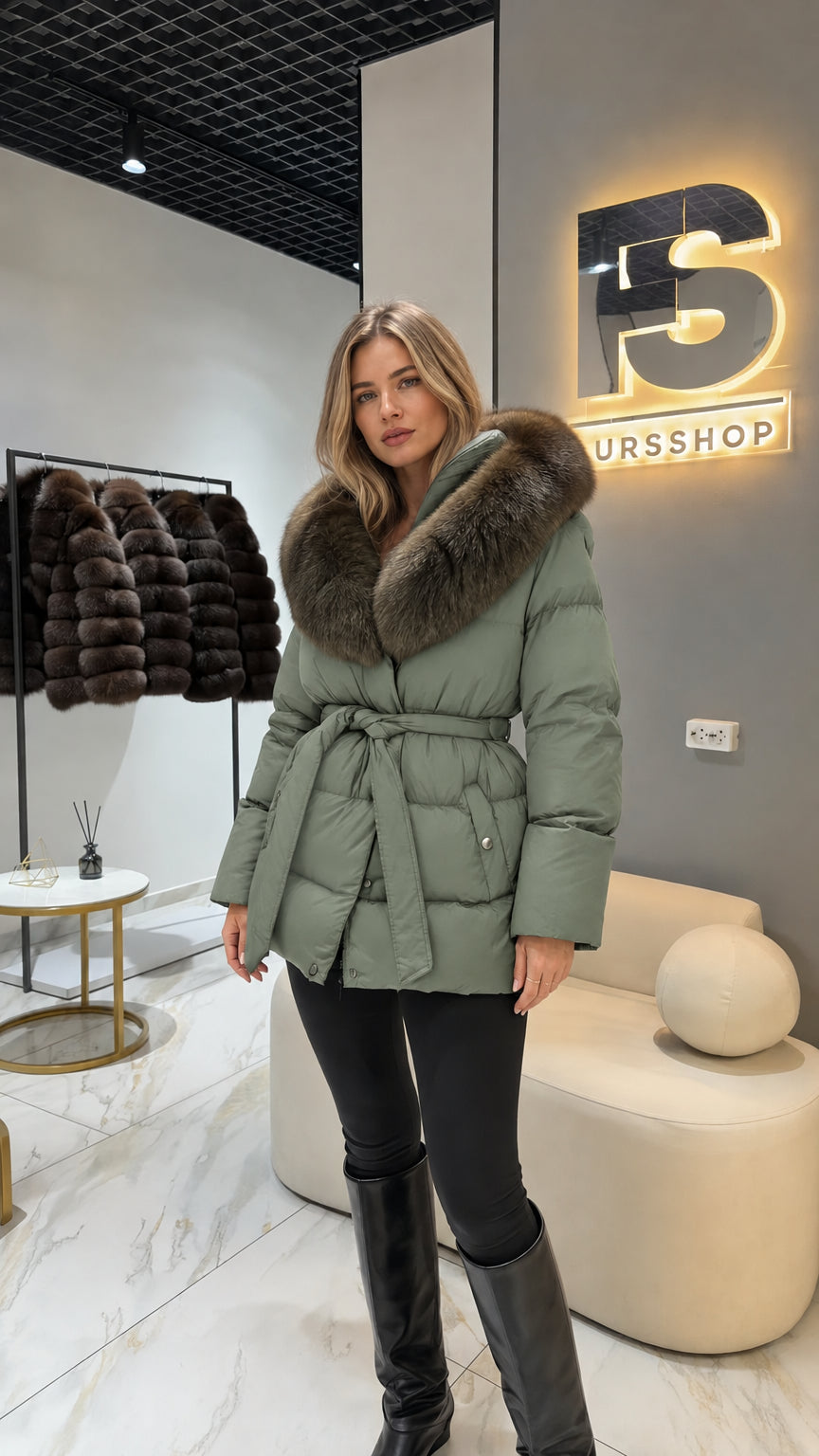 Model wearing sage green quilted puffer coat with tie belt