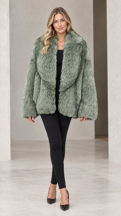 Front view of woman wearing sage green plush faux fur coat