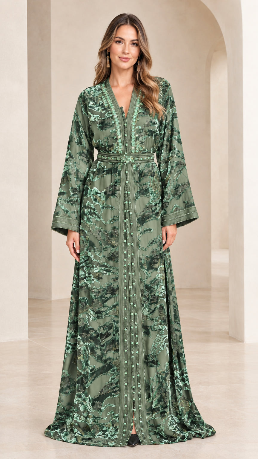 Full-length view of woman wearing sage green embroidered velvet kaftan dress