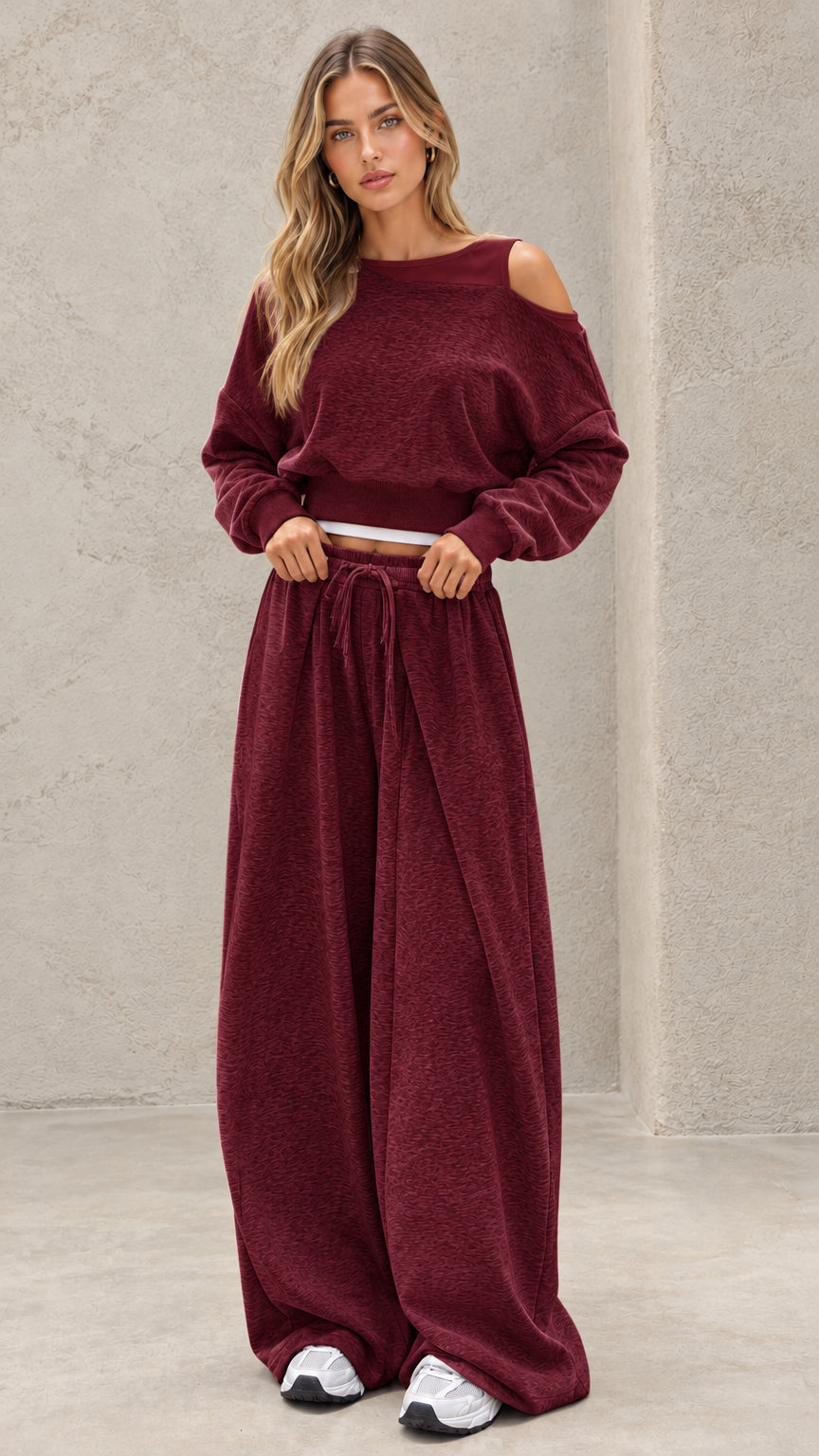 Full-length view of model wearing burgundy wine cropped sweatshirt and wide leg lounge set