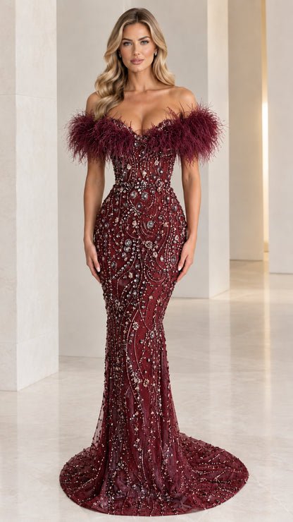 Front view of burgundy off-the-shoulder beaded mermaid formal dress with feather trim