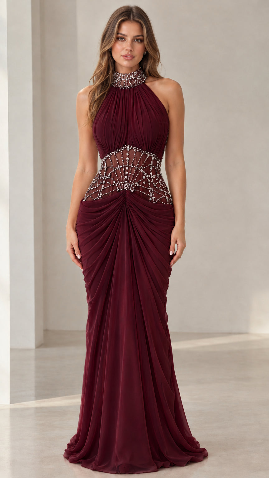 Front view of burgundy wine halter neck beaded illusion evening gown