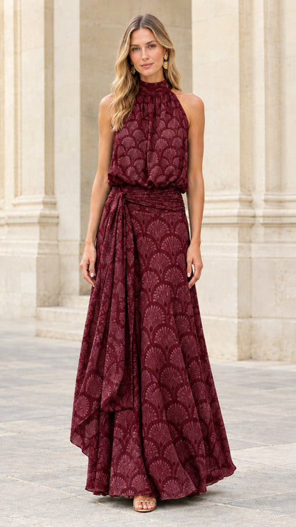 Front view of burgundy halter neck maxi dress with draped sash detail