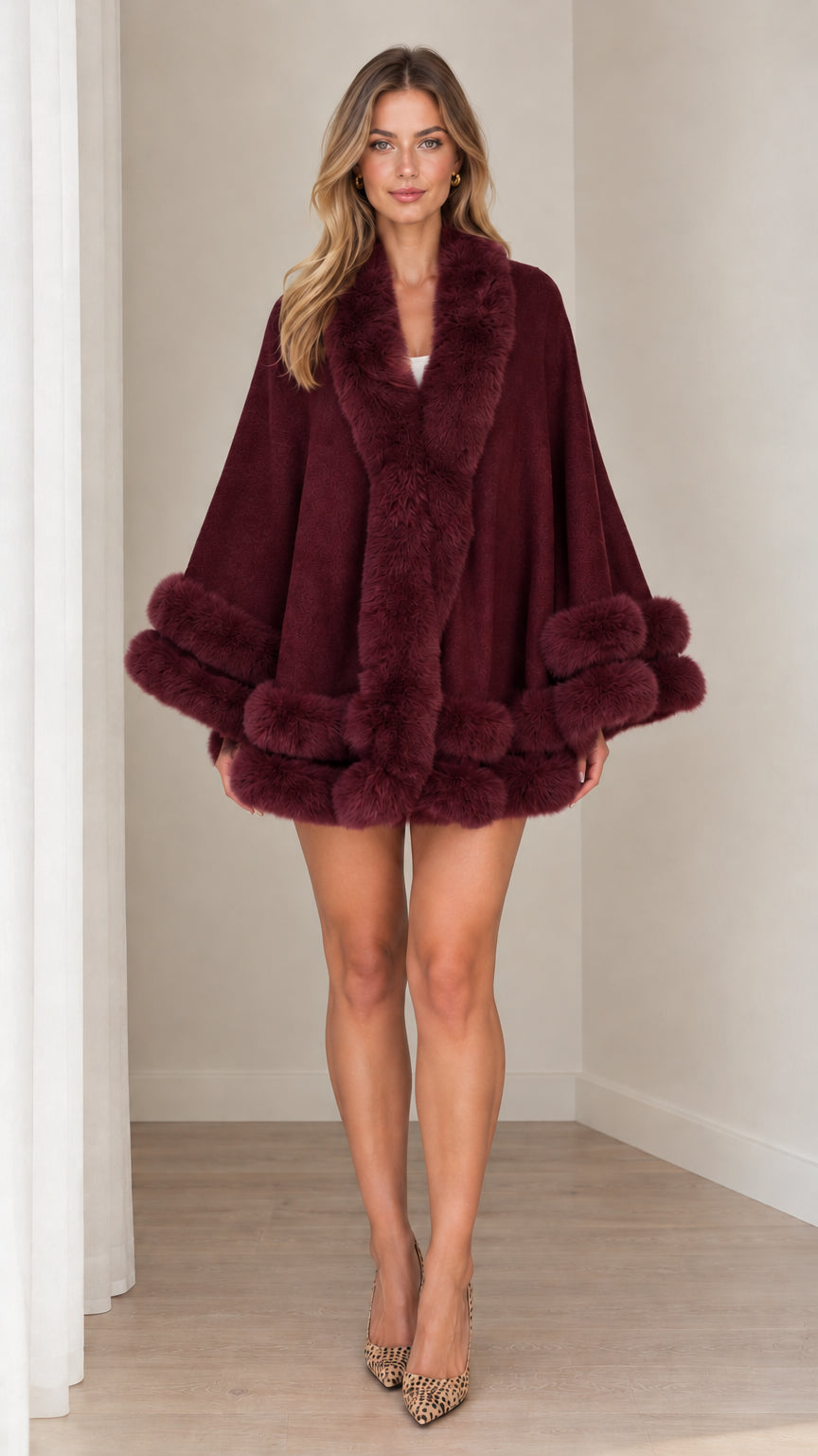 Model wearing burgundy wine faux fur trim cape coat with open front