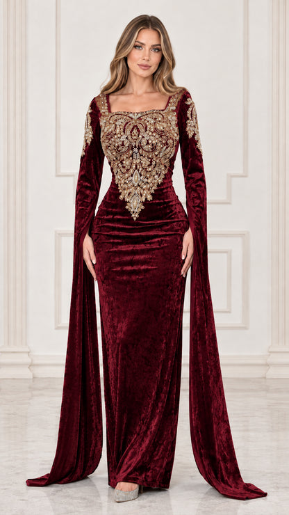 Front view of burgundy red velvet evening gown featuring ornate gold embroidery and cape sleeves