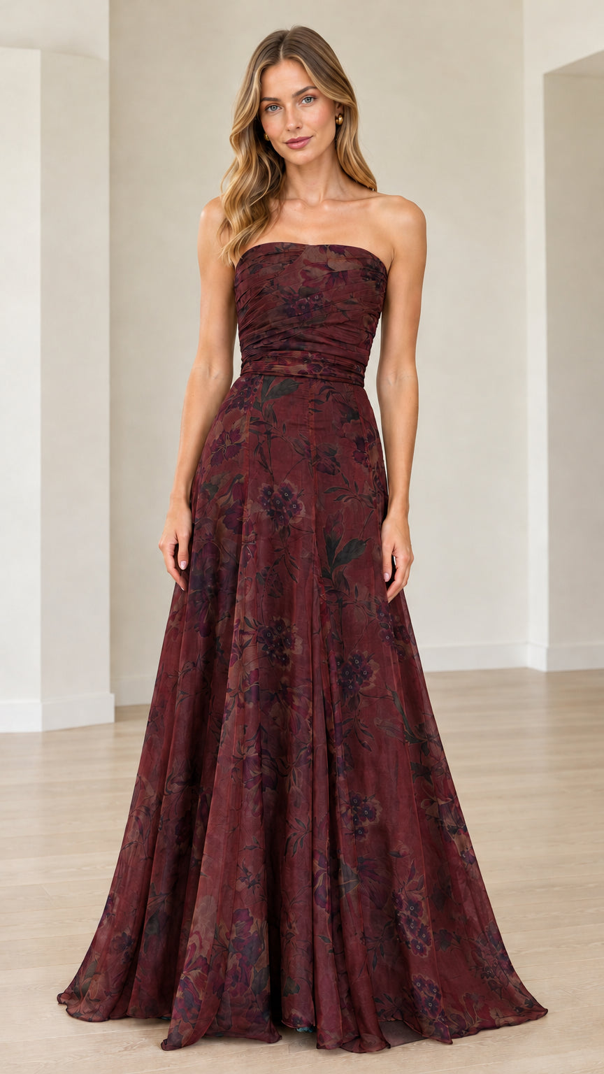 Front view of model wearing burgundy wine floral strapless maxi gown