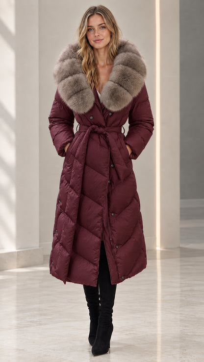 Front full-length view of woman wearing burgundy wine belted maxi puffer coat with plush fur collar
