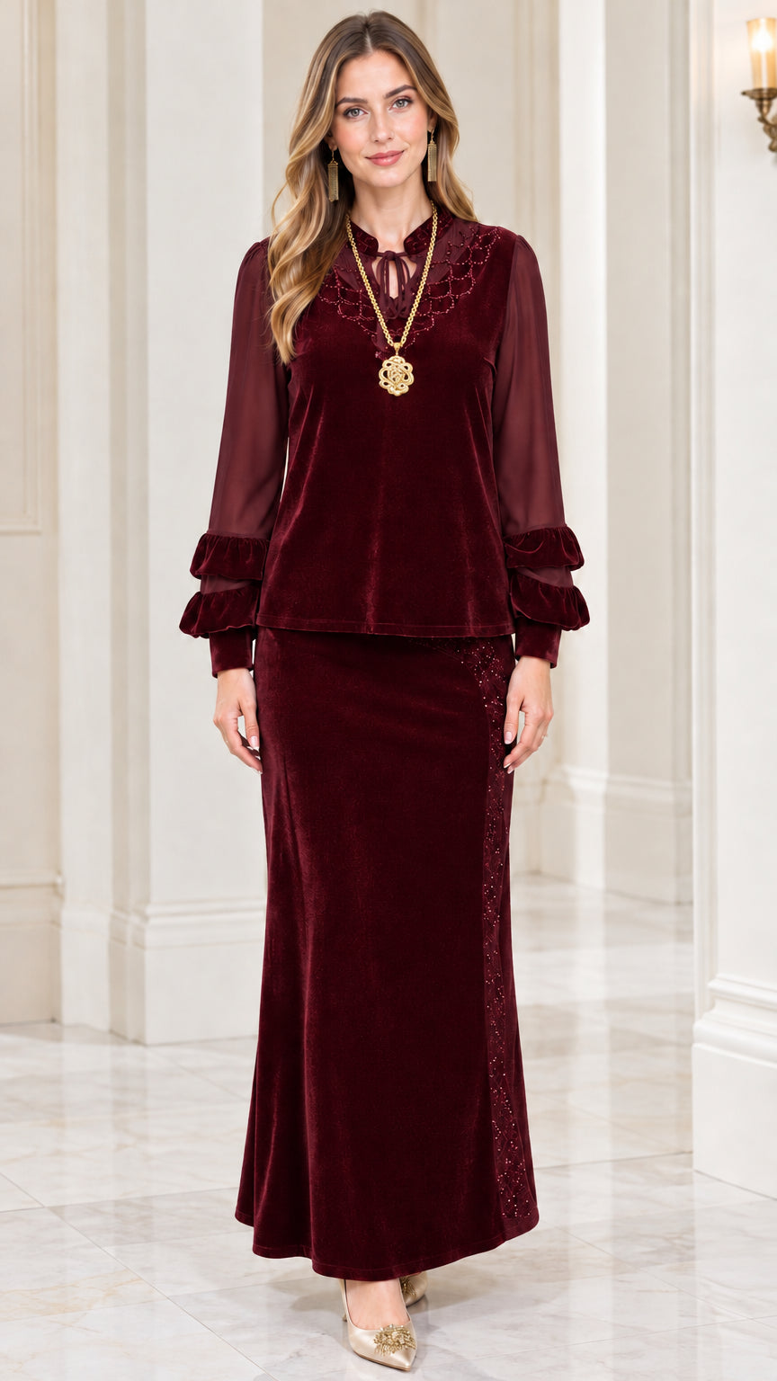 Front view of model wearing burgundy velvet two-piece maxi skirt set