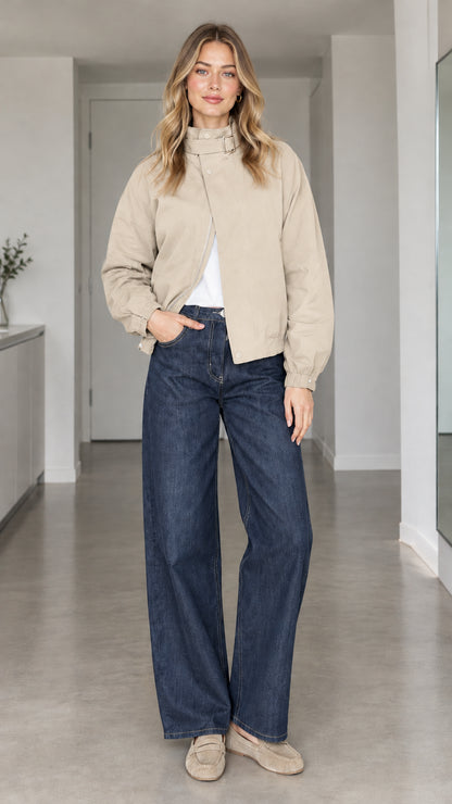 Front view of model wearing beige high-collar buckle bomber jacket