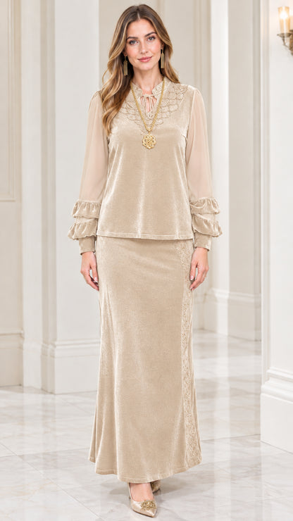 Front view of model wearing champagne beige velvet two-piece maxi skirt set